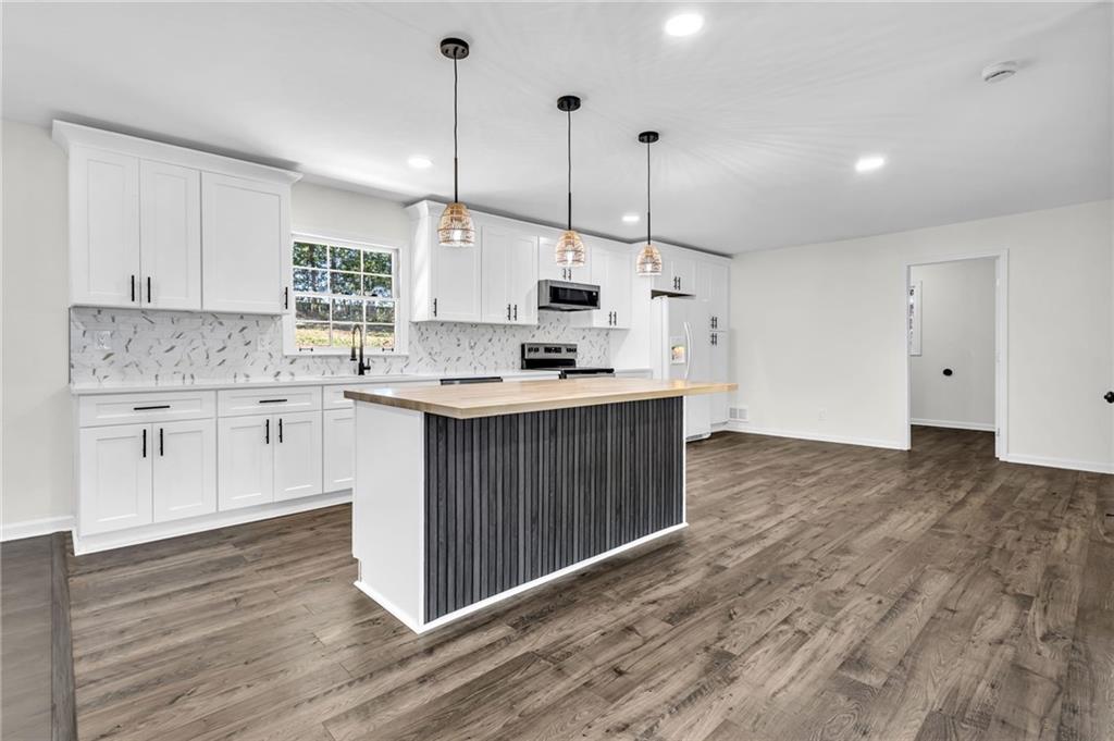 2401 Winshire Drive Decatur, GA 30035 - Photo 25 of 35 a kitchen with kitchen island a sink stainless steel appliances and cabinets