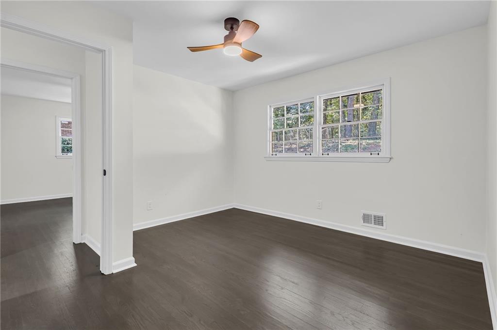 2401 Winshire Drive Decatur, GA 30035 - Photo 3 of 35 a view of an empty room with wooden floor and a window