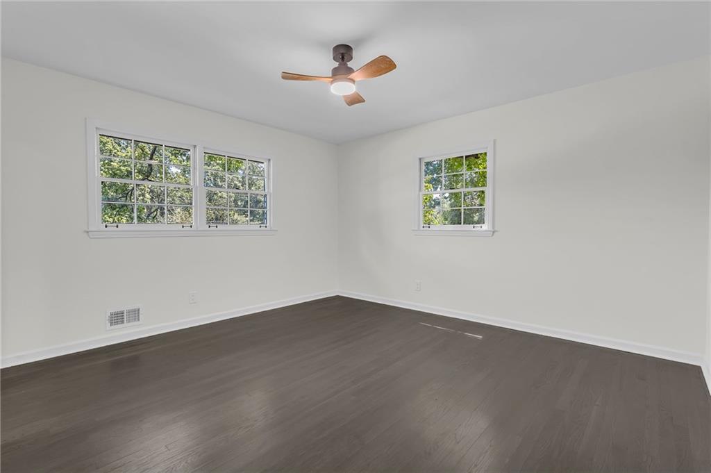 2401 Winshire Drive Decatur, GA 30035 - Photo 8 of 35 an empty room with wooden floor and windows