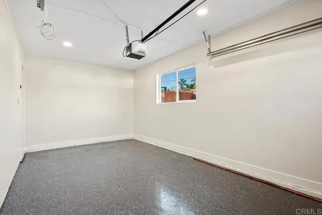 an empty room with a windows and ceiling fan