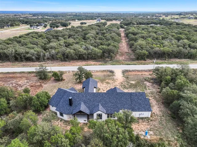 an aerial view of a house with a yard