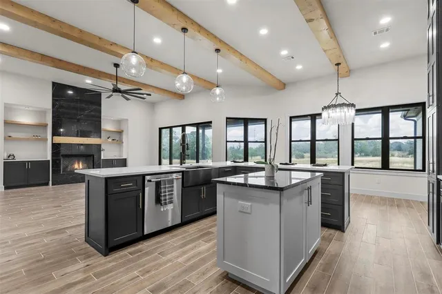 a kitchen with stainless steel appliances granite countertop plenty wooden cabinets and wooden floor