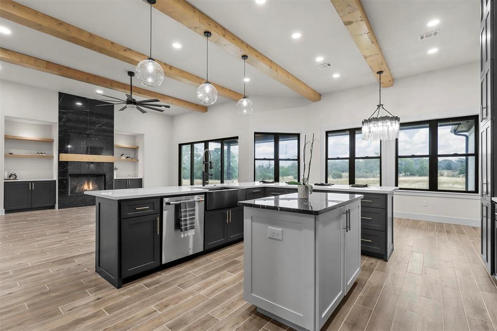 4018 Ken Road Tolar, TX 76476 - Photo 21 of 40 a kitchen with stainless steel appliances granite countertop plenty wooden cabinets and wooden floor