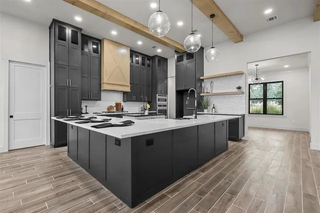 a kitchen with stainless steel appliances granite countertop a stove and a sink