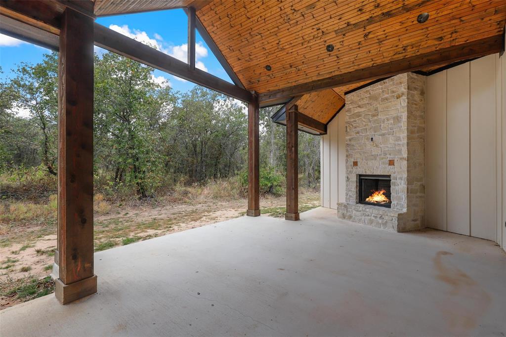 4018 Ken Road Tolar, TX 76476 - Photo 8 of 40 a view of an empty room with a fireplace and a window