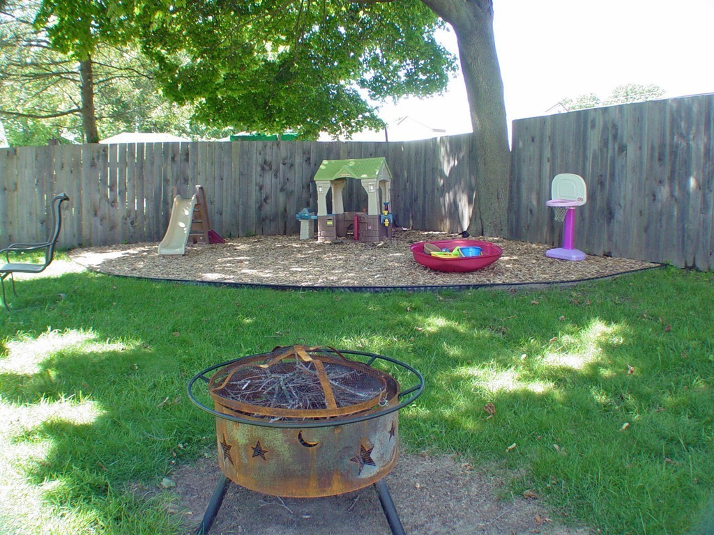 384 Anthony Street Fall River, MA 02721 - Photo 3 of 26 a view of a backyard with table and chairs potted plants and wooden fence