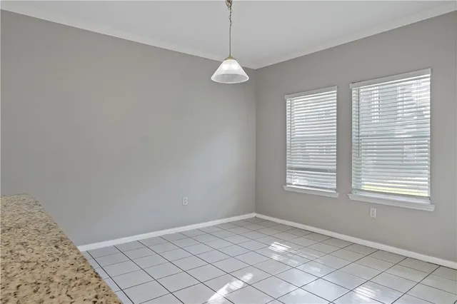 an empty room with cabinet and mirrors
