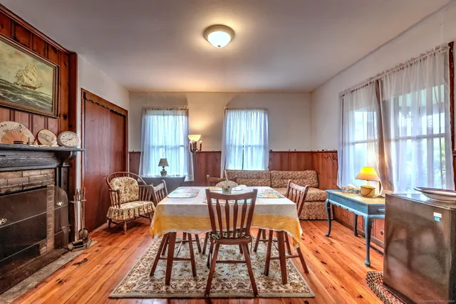 a dining room with furniture and a fireplace