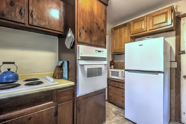 a kitchen with a refrigerator and a stove