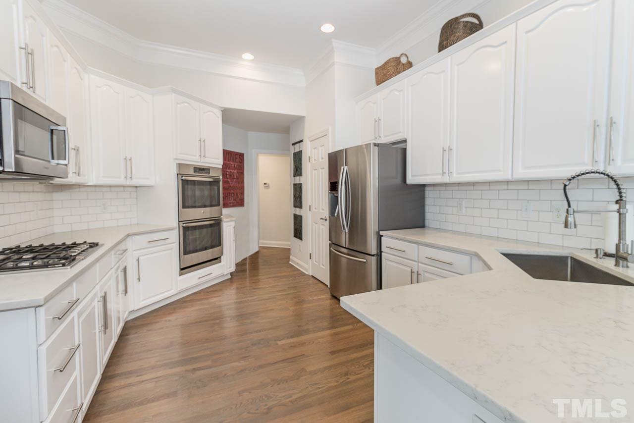 12507 Megan Hill Court Raleigh, NC 27614 - Photo 11 of 39 a kitchen with refrigerator and cabinets