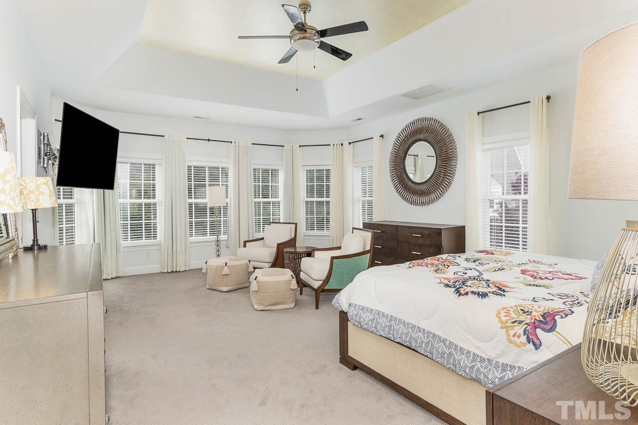 12507 Megan Hill Court Raleigh, NC 27614 - Photo 15 of 39 a bedroom with a bed and a flat screen tv