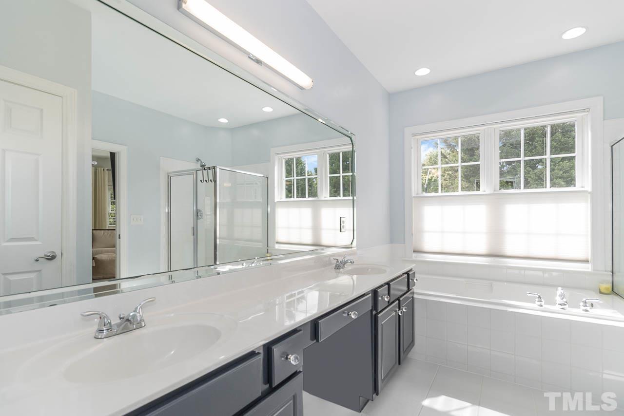 12507 Megan Hill Court Raleigh, NC 27614 - Photo 19 of 39 a bathroom with a tub sink and mirror
