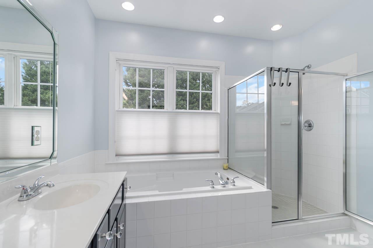 12507 Megan Hill Court Raleigh, NC 27614 - Photo 20 of 39 a bathroom with a tub sink and mirror