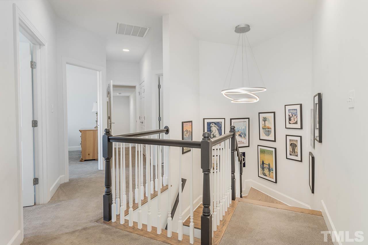12507 Megan Hill Court Raleigh, NC 27614 - Photo 39 of 39 a view of a hallway with lots of white furniture