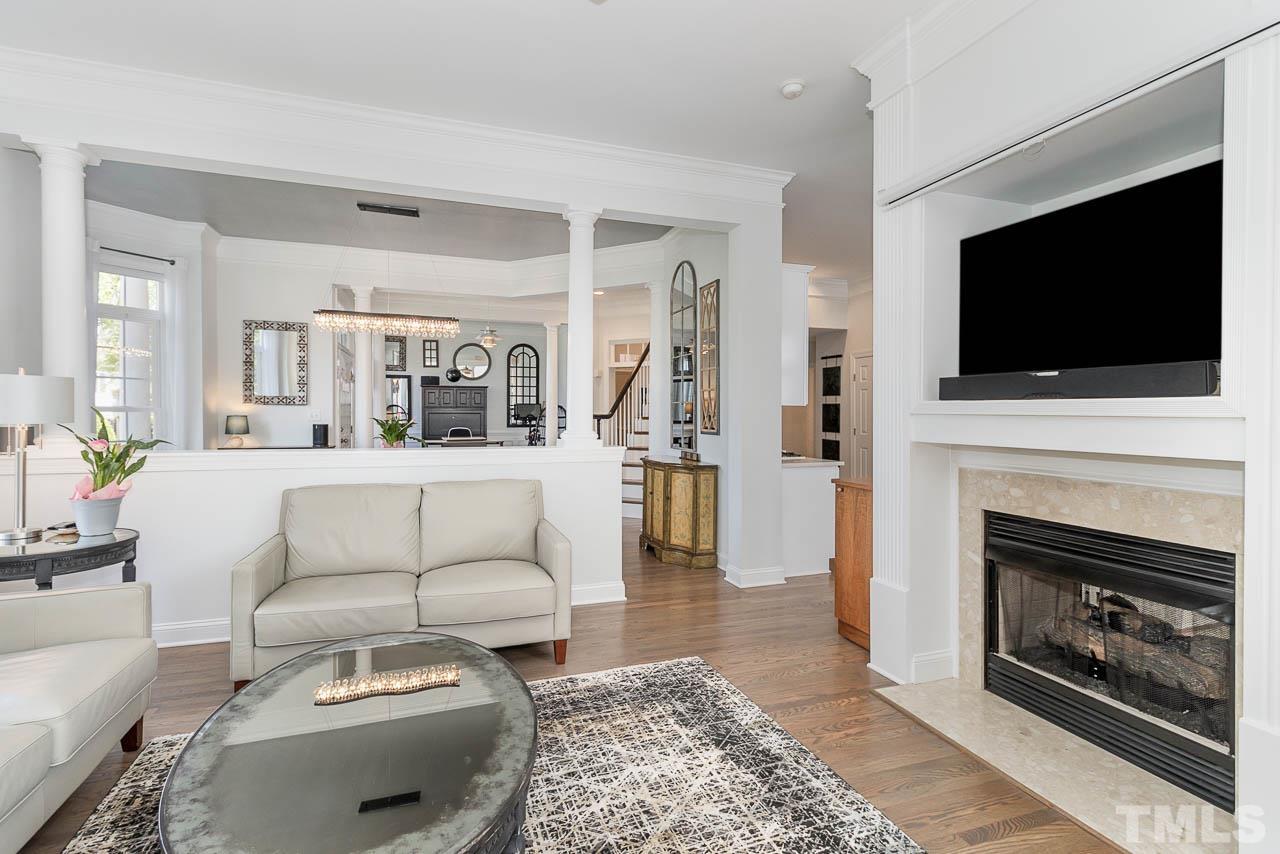12507 Megan Hill Court Raleigh, NC 27614 - Photo 7 of 39 a living room with furniture a flat screen tv and a fireplace