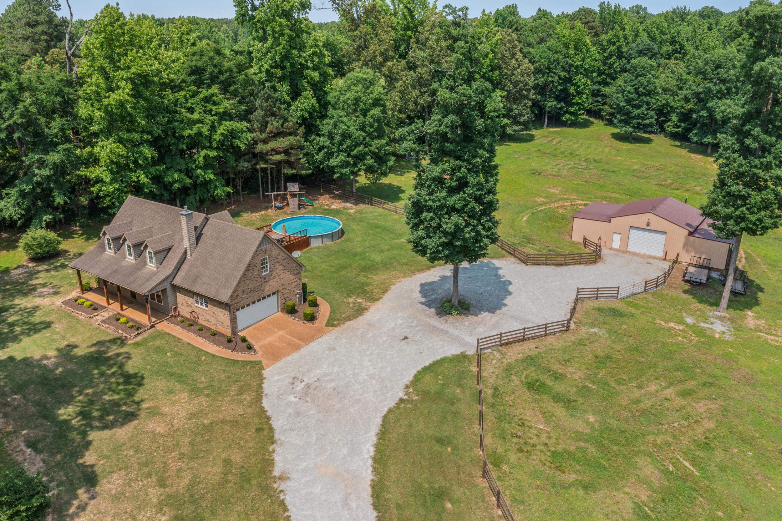 6415 Lagrange Road Somerville, TN 38068 - Photo 1 of 32 View of rural area with a forest and a pool area