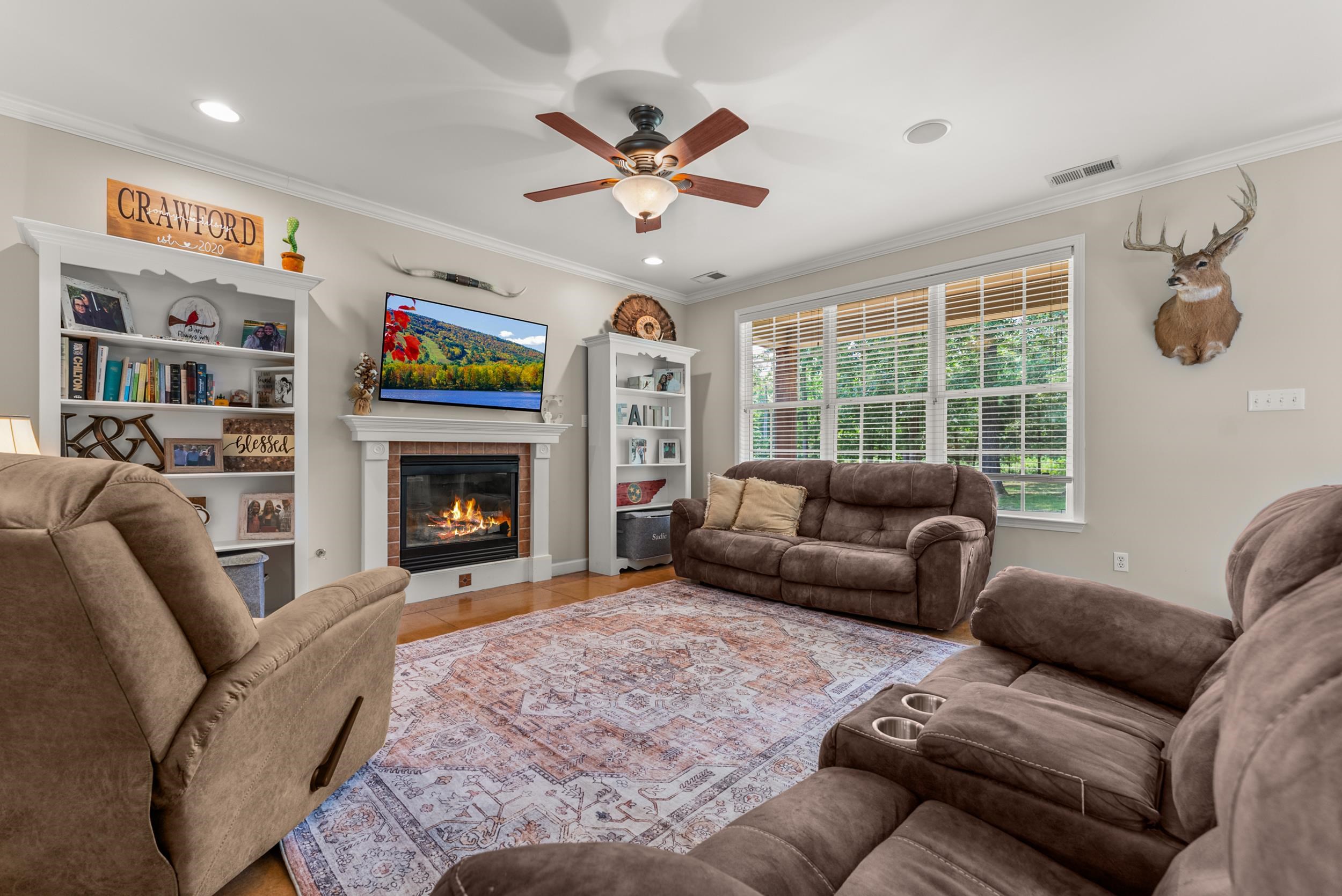 6415 Lagrange Road Somerville, TN 38068 - Photo 13 of 32 Living area featuring a ceiling fan, crown molding, a glass covered fireplace, and recessed lighting