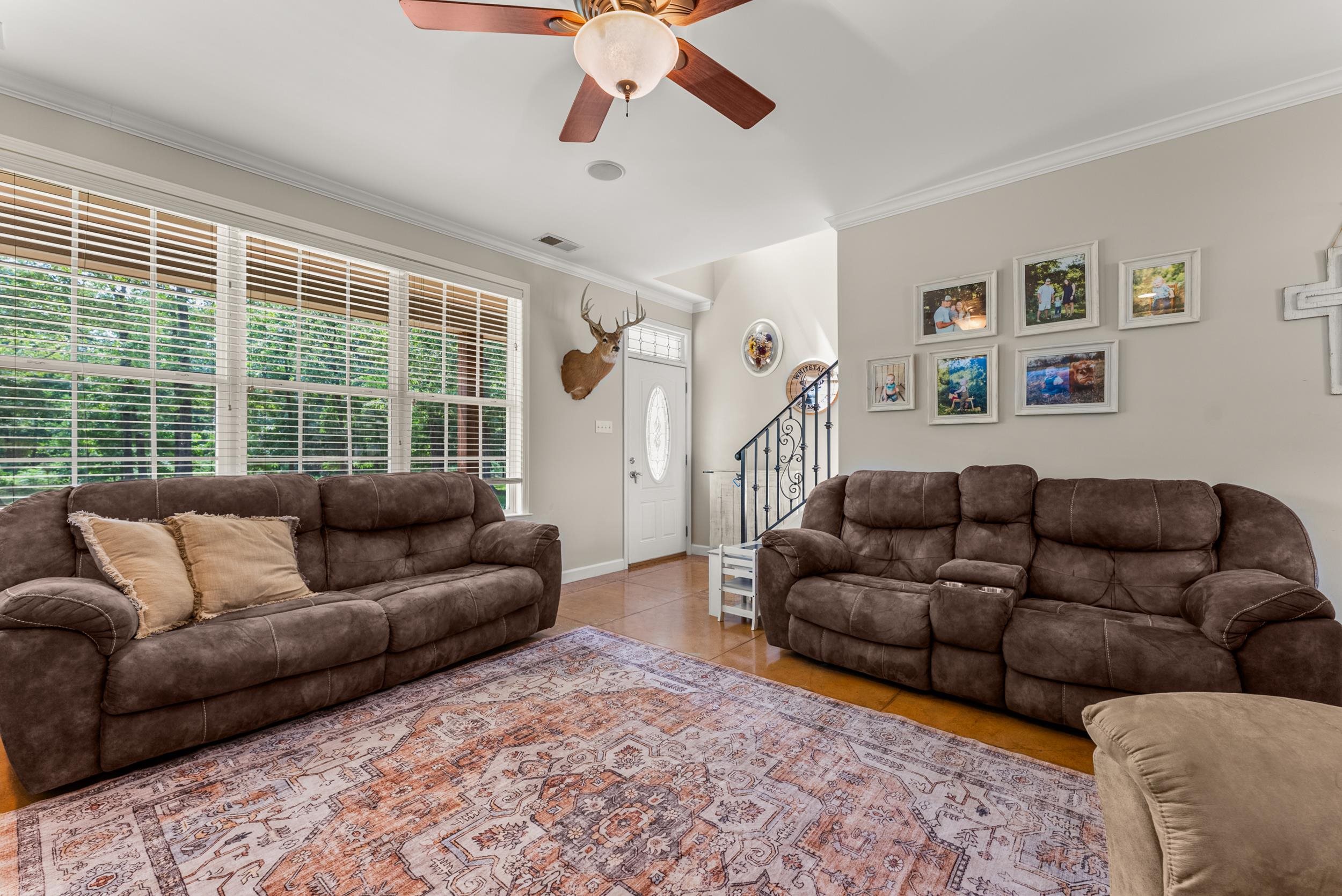 6415 Lagrange Road Somerville, TN 38068 - Photo 15 of 32 Tiled living area featuring ornamental molding, ceiling fan, stairway, and baseboards