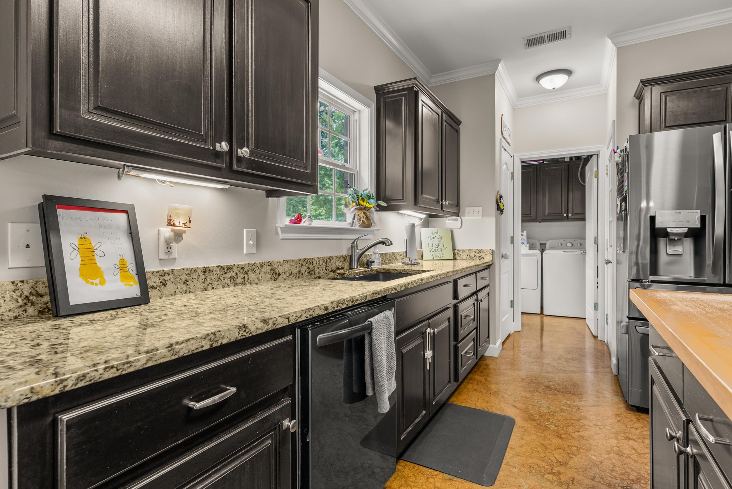 6415 Lagrange Road Somerville, TN 38068 - Photo 18 of 32 Kitchen with dishwasher, independent washer and dryer, stainless steel fridge with ice dispenser, a sink, and ornamental molding