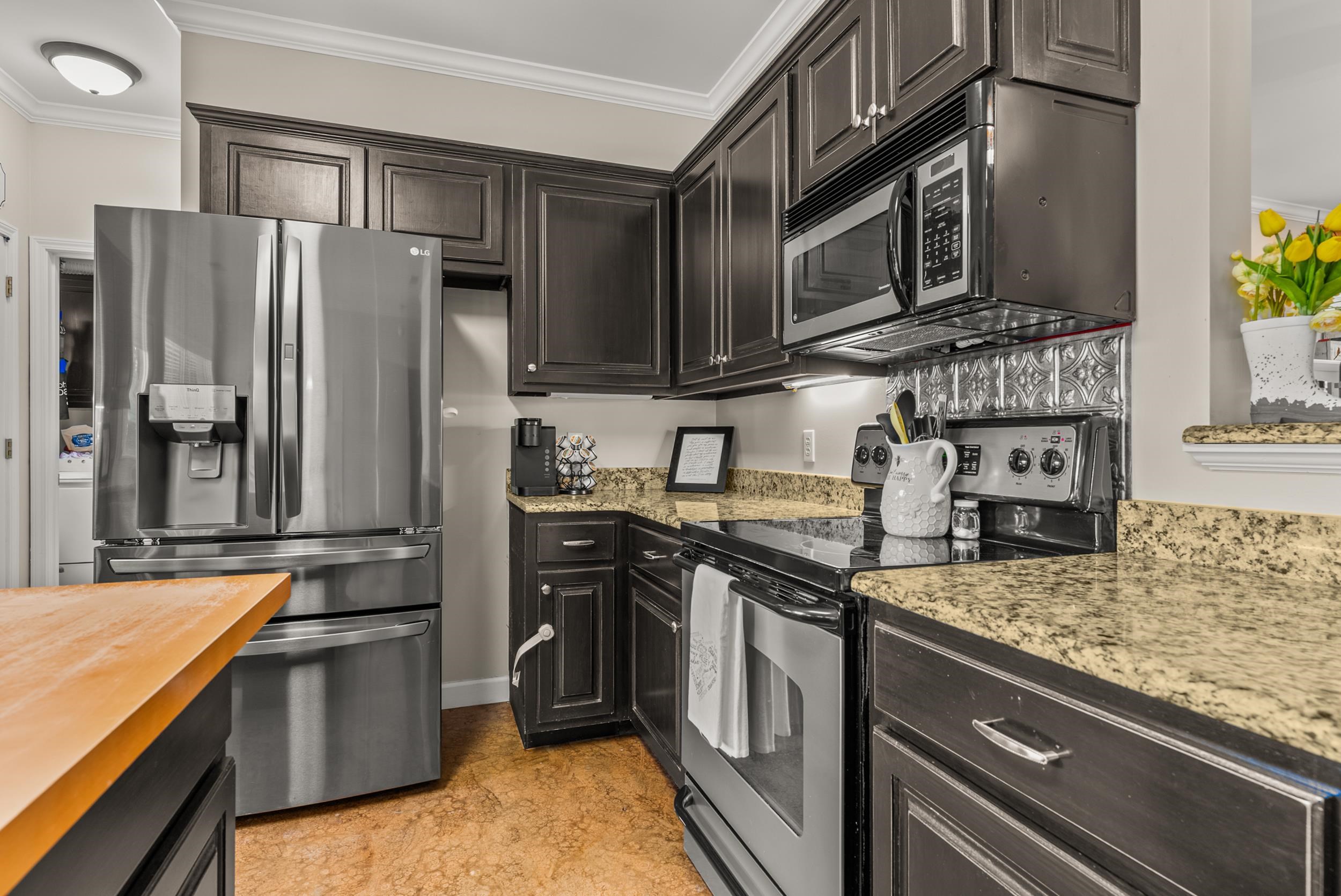6415 Lagrange Road Somerville, TN 38068 - Photo 20 of 32 Kitchen with stainless steel appliances, crown molding, and light stone countertops