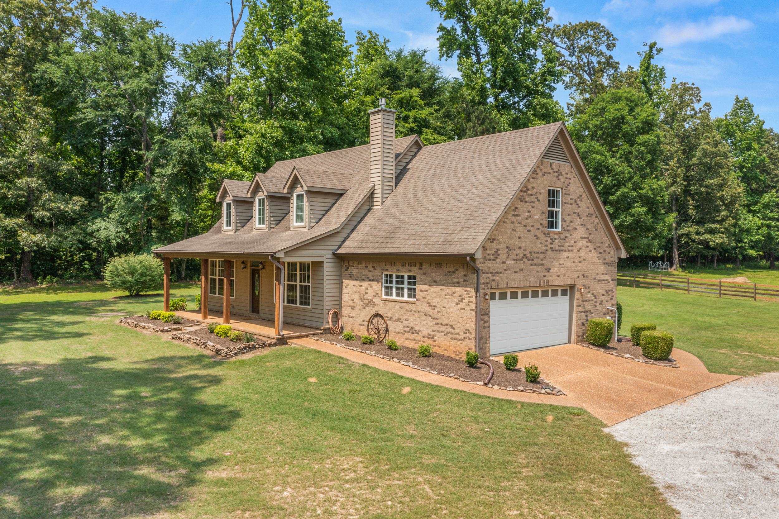6415 Lagrange Road Somerville, TN 38068 - Photo 2 of 32 View of front of house with a garage, brick siding, concrete driveway, covered porch, and roof with shingles