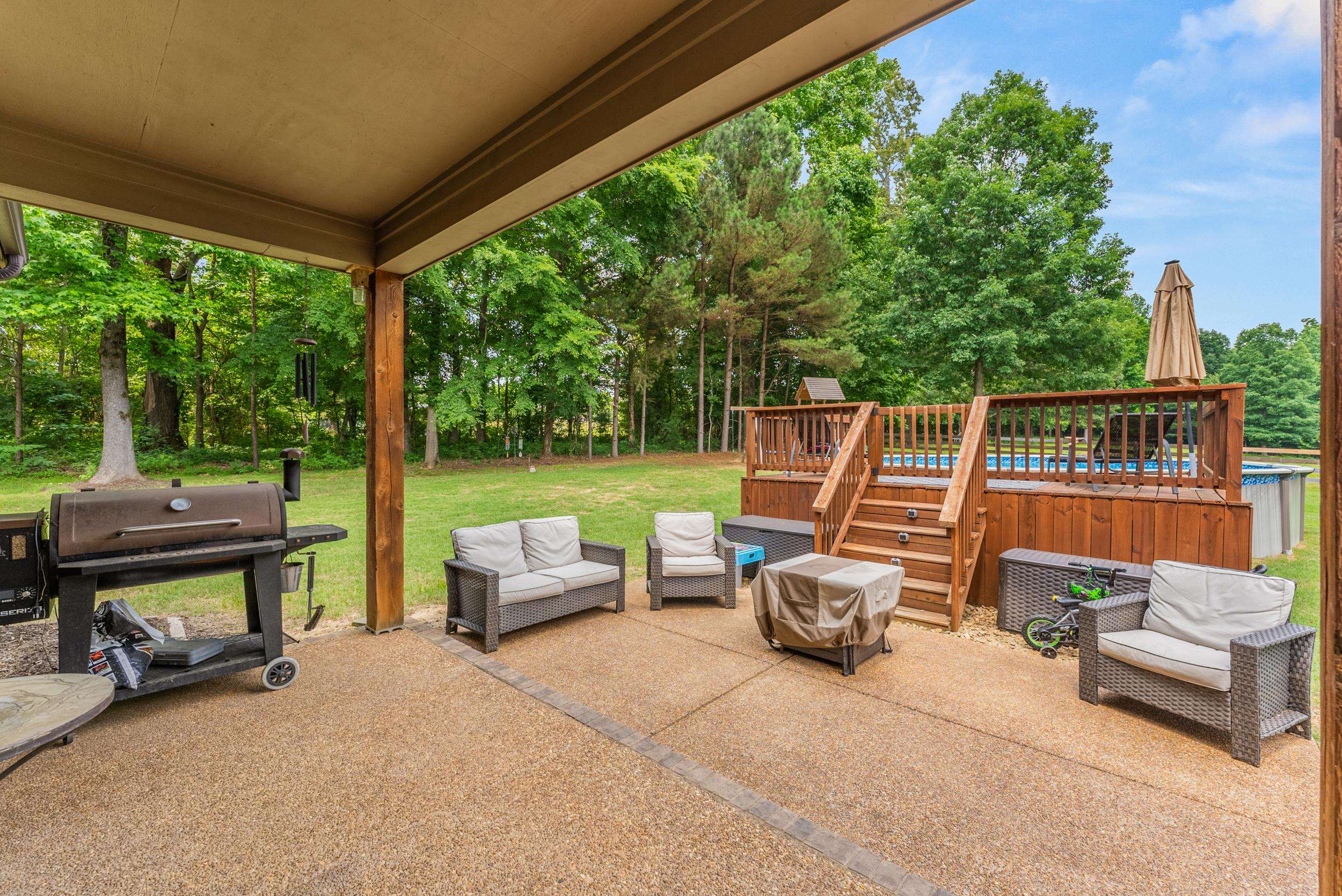 6415 Lagrange Road Somerville, TN 38068 - Photo 3 of 32 View of patio / terrace featuring a jacuzzi, a deck, an outdoor hangout area, area for grilling, and view of wooded area