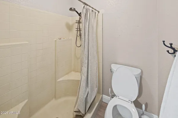 a bathroom with a toilet and shower