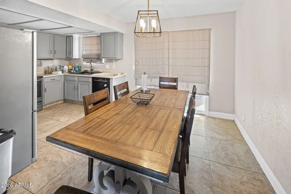 a kitchen with a sink a stove and chairs