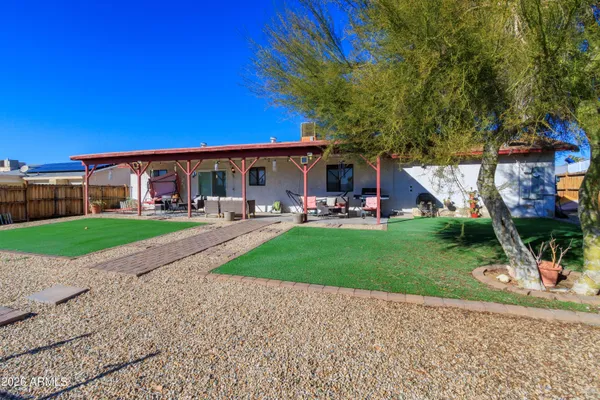 a view of a house with a yard porch and sitting area