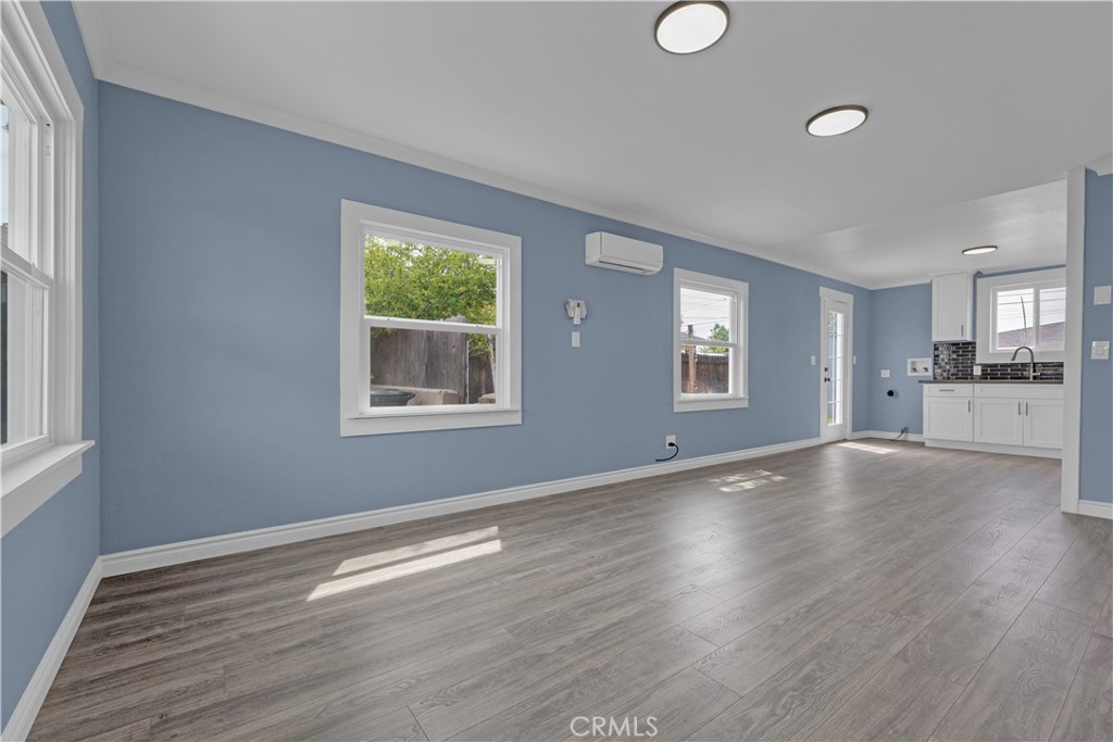34945 Ave B Yucaipa, CA 92399 - Photo 13 of 69 a view of an empty room with wooden floor and a window