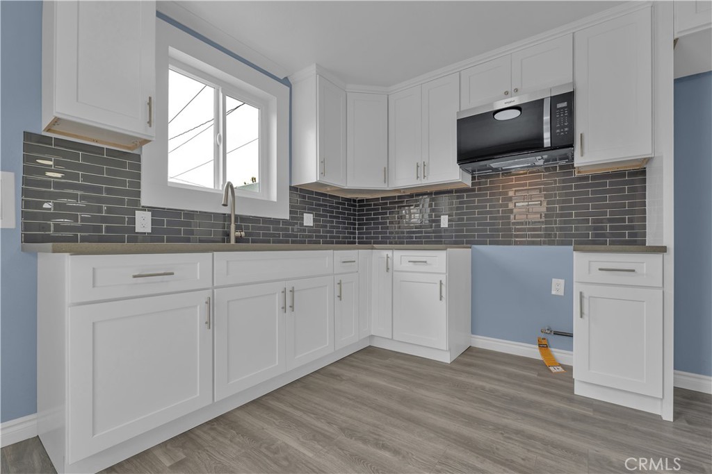 34945 Ave B Yucaipa, CA 92399 - Photo 17 of 69 a kitchen with granite countertop white cabinets and white appliances