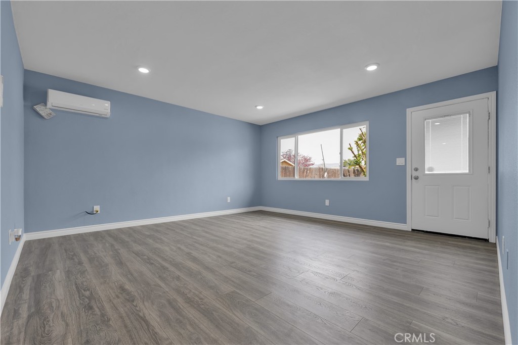 34945 Ave B Yucaipa, CA 92399 - Photo 34 of 69 a view of an empty room with wooden floor and a window