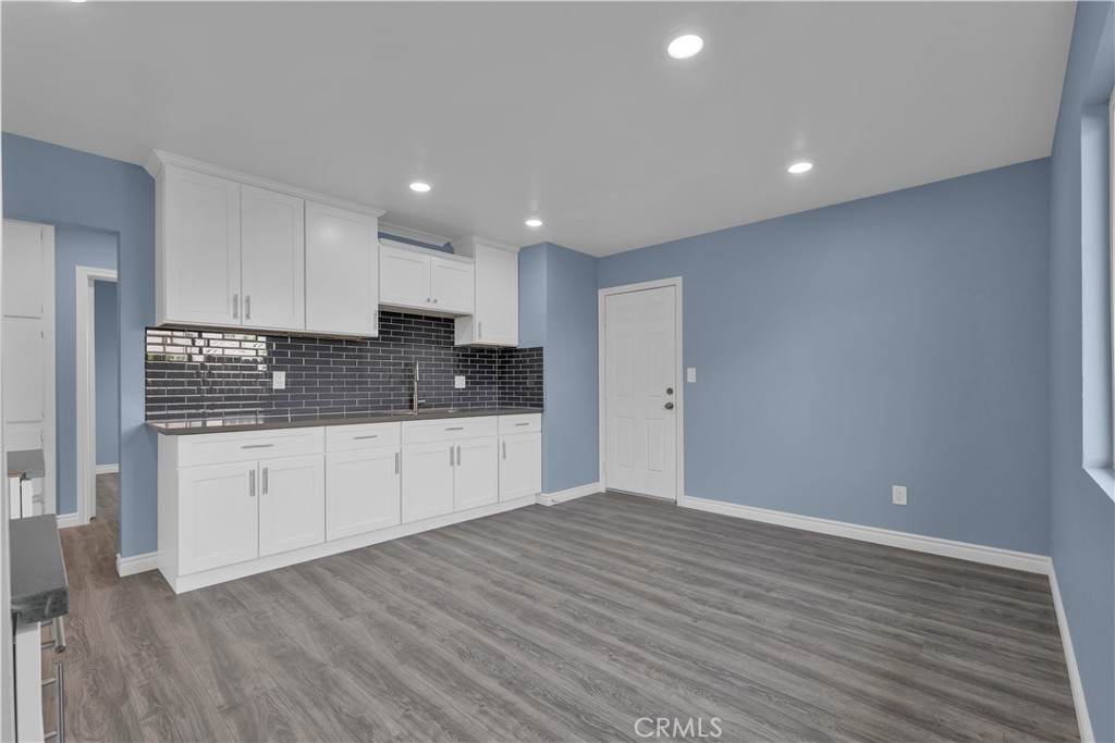 34945 Ave B Yucaipa, CA 92399 - Photo 37 of 69 a view of kitchen with granite countertop cabinets and wooden floor