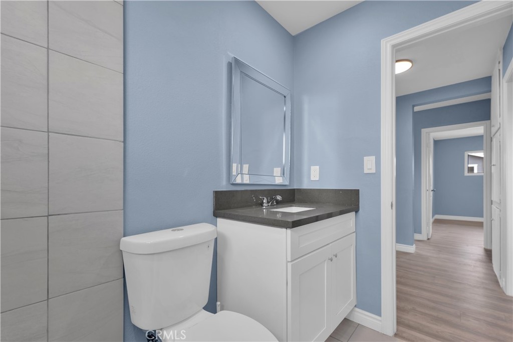 34945 Ave B Yucaipa, CA 92399 - Photo 45 of 69 a bathroom with a granite countertop toilet sink and mirror