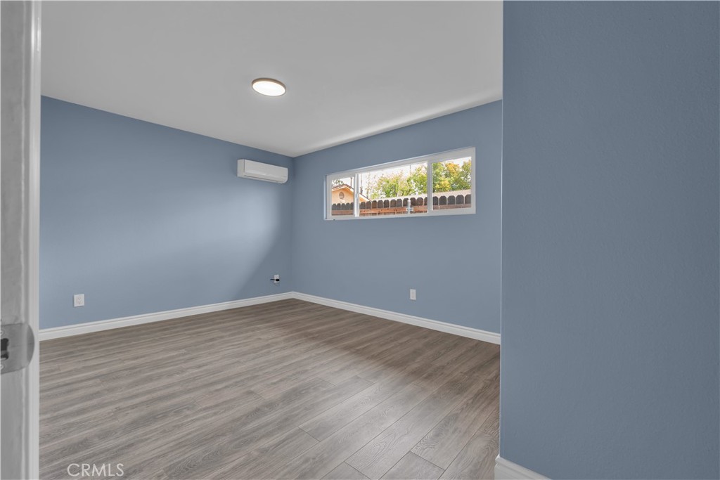 34945 Ave B Yucaipa, CA 92399 - Photo 51 of 69 a view of an empty room with wooden floor and windows