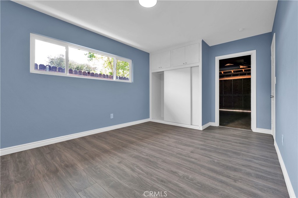 34945 Ave B Yucaipa, CA 92399 - Photo 53 of 69 a view of an empty room with wooden floor and a window