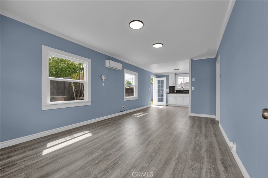 34945 Ave B Yucaipa, CA 92399 - Photo 6 of 69 a view of an empty room with wooden floor and a window