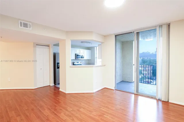 a kitchen with granite countertop a refrigerator and a stove top oven