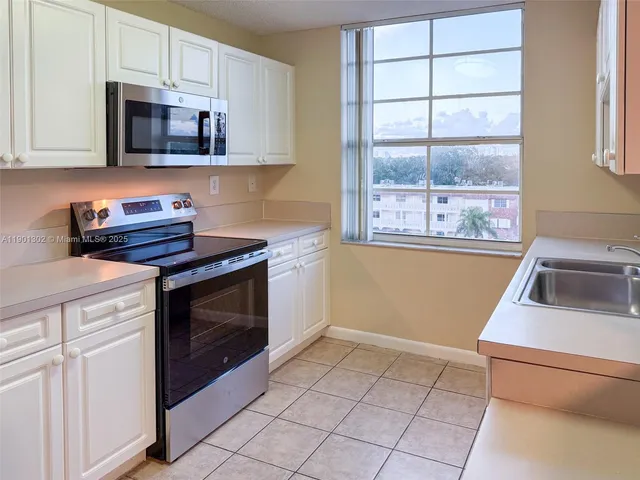 a kitchen with a sink a refrigerator and a sink