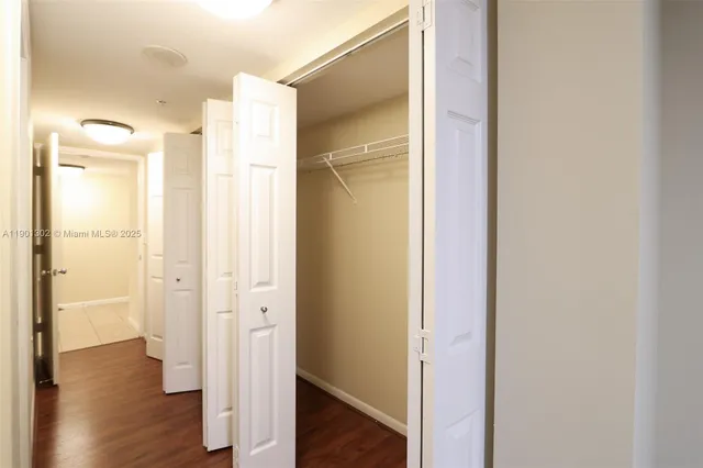a bathroom with a granite countertop sink a toilet and a mirror
