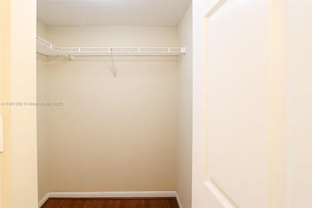 a view of a room with wooden floor and windows
