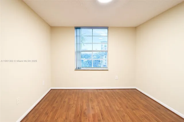 a view of an empty room and wooden floor