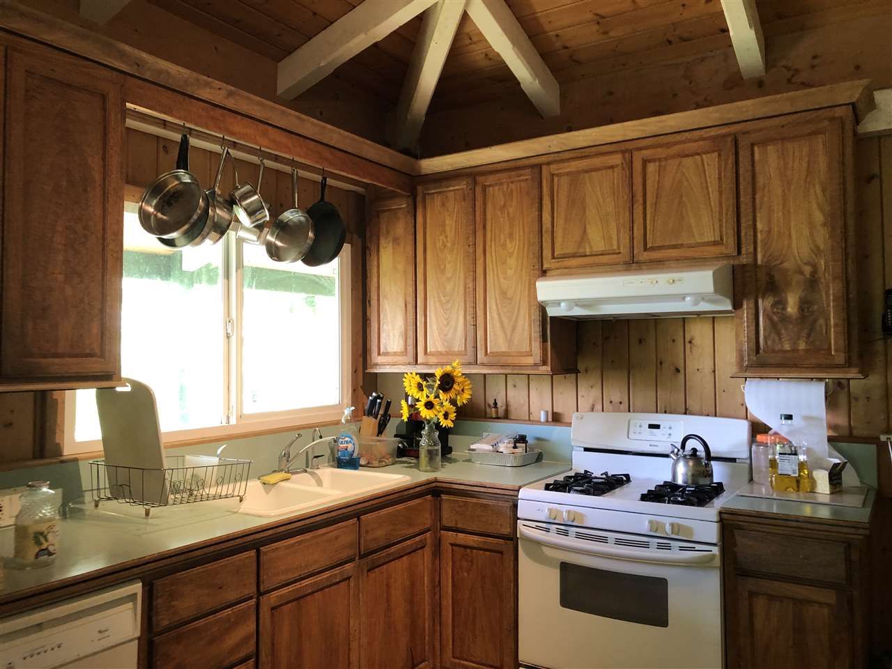 19 Door Of Faith Road Haiku, HI 96708 - Photo 11 of 30 a kitchen with a sink cabinets window and stainless steel appliances