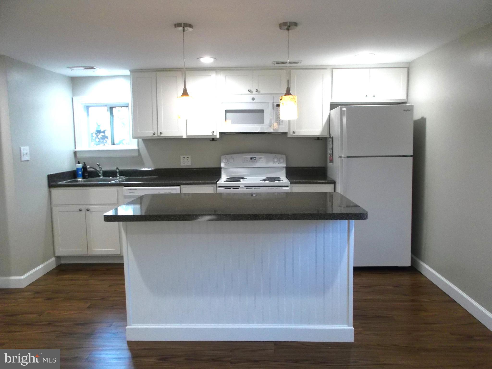 278 Ridge Road Browns Mills, NJ 08015 - Photo 4 of 22 a kitchen with kitchen island stainless steel appliances a sink and a refrigerator