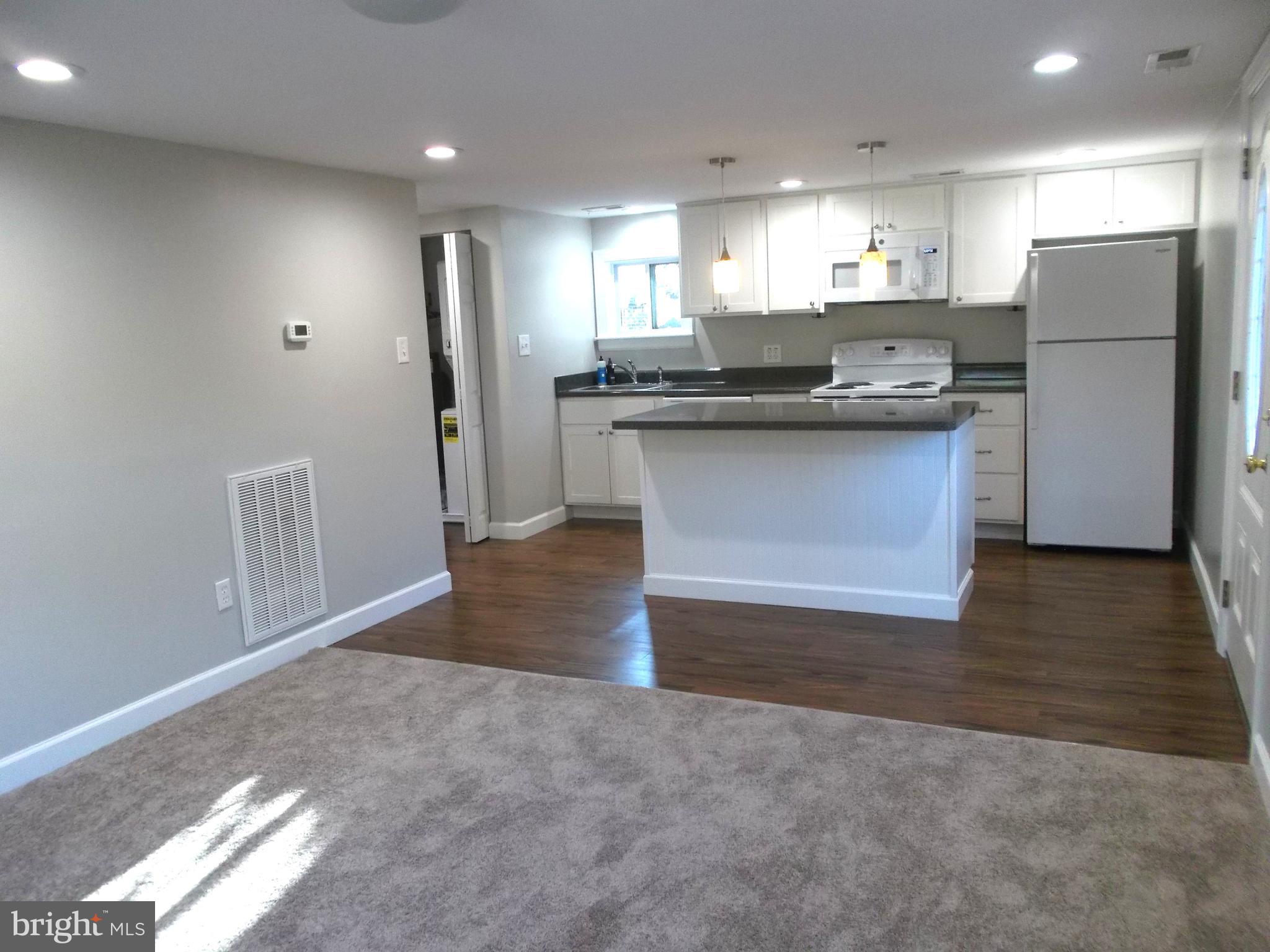 278 Ridge Road Browns Mills, NJ 08015 - Photo 8 of 22 a view of kitchen with refrigerator stove and wooden cabinets