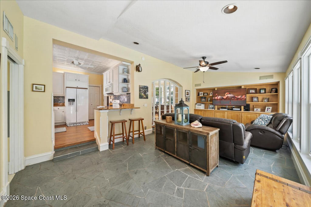 1110 Riverside Drive Titusville, FL 32780 - Photo 15 of 50 a living room with furniture and a kitchen