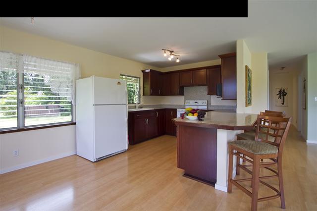 40 Kapuai Road Haiku, HI 96708 - Photo 3 of 29 a kitchen with stainless steel appliances granite countertop a refrigerator sink and cabinets