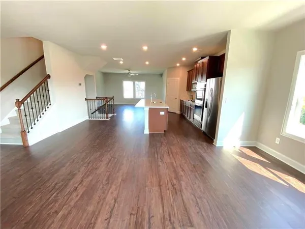 a view of a living room and dining room with wooden floor