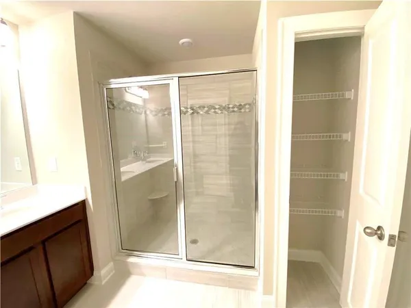 a bathroom with a glass shower door