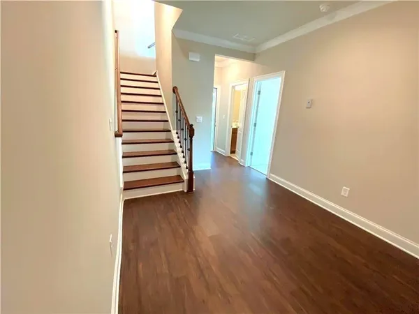 a view of a room with wooden floor